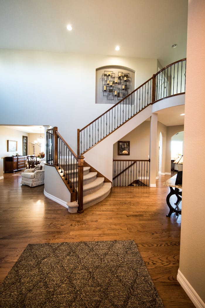 services-02 Spacious modern interior showcasing a stylish wooden staircase and elegant decor.